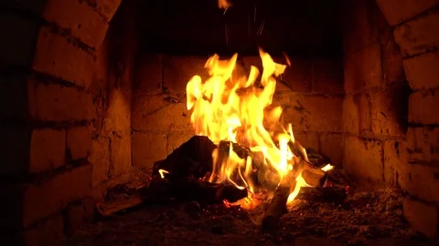 A fire burns in a fireplace, Fire to keep warm Stock Footage 85389706