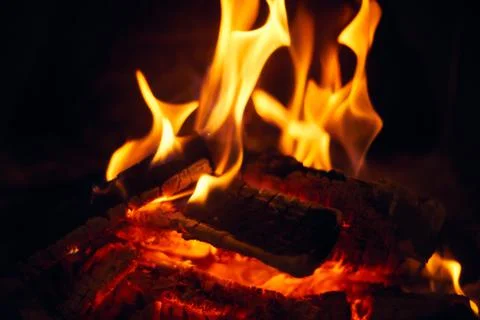 A fire burns in a fireplace, Fire to keep warm. Logs burning in a fireplace Stock Photos