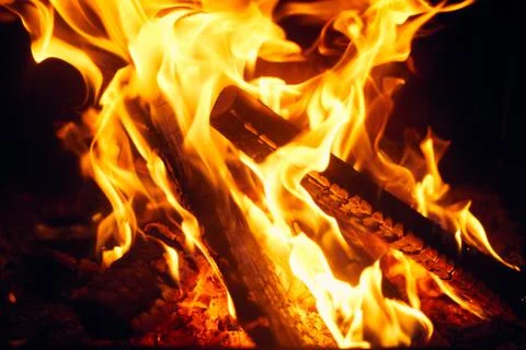 A fire burns in a fireplace, Fire to keep warm. Logs burning in a fireplace Stock Photos