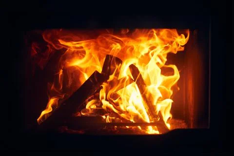 A fire burns in a fireplace, Fire to keep warm. Logs burning in a fireplace Foto stock