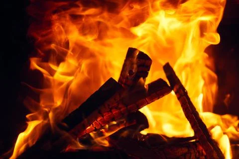 A fire burns in a fireplace, Fire to keep warm. Logs burning in a fireplace Stock Photos