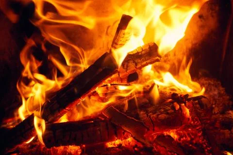 A fire burns in a fireplace, Fire to keep warm. Logs burning in a fireplace Stock Photos