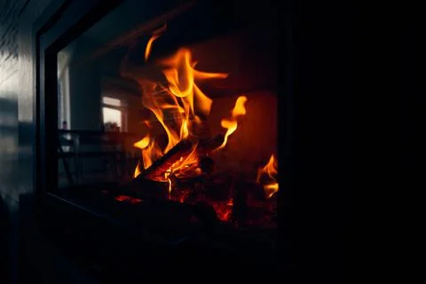 A fire burns in a fireplace, Fire to keep warm. Logs burning in a fireplace Foto stock