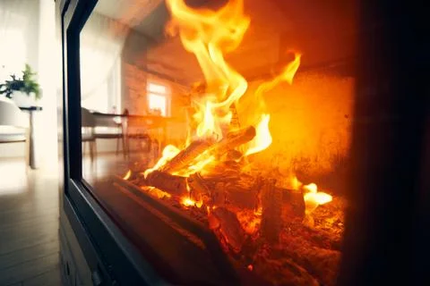 A fire burns in a fireplace, Fire to keep warm. Logs burning in a fireplace Stock-Fotos