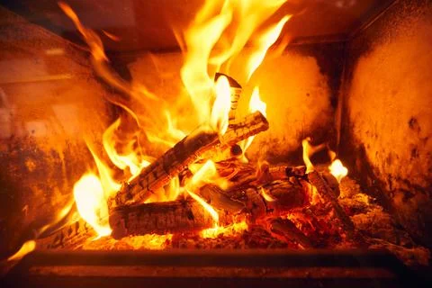 A fire burns in a fireplace, Fire to keep warm. Logs burning in a fireplace Stock Photos