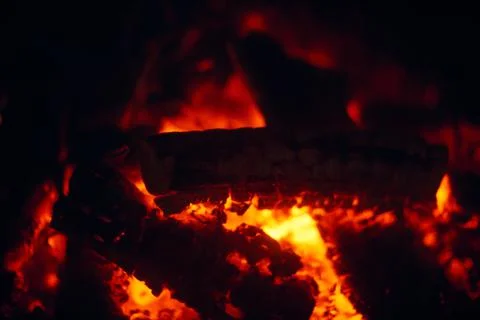 A fire burns in a fireplace, Fire to keep warm. Logs burning in a fireplace Stock Photos