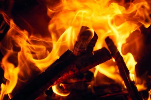 A fire burns in a fireplace, Fire to keep warm. Logs burning in a fireplace Stock Photos