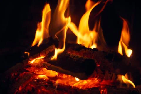 A fire burns in a fireplace, Fire to keep warm. Logs burning in a fireplace Stock Photos