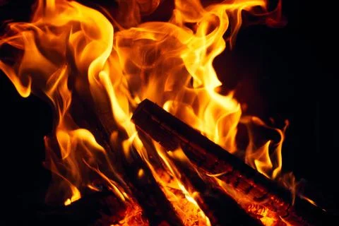 A fire burns in a fireplace, Fire to keep warm. Logs burning in a fireplace Stock Photos