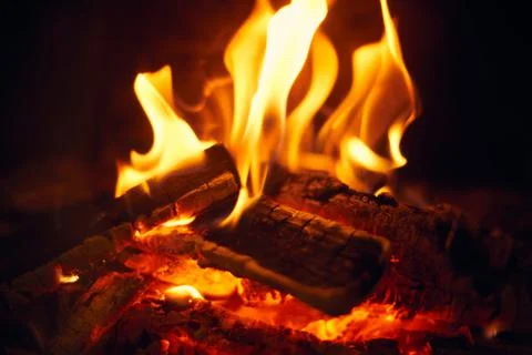 A fire burns in a fireplace, Fire to keep warm. Logs burning in a fireplace Stock Photos