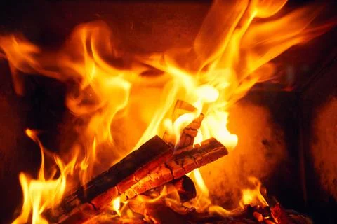 A fire burns in a fireplace, Fire to keep warm. Logs burning in a fireplace Foto stock