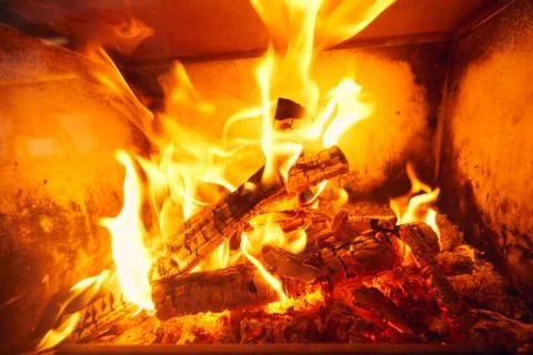 A fire burns in a fireplace, Fire to keep warm. Logs burning in a fireplace Stock Photos