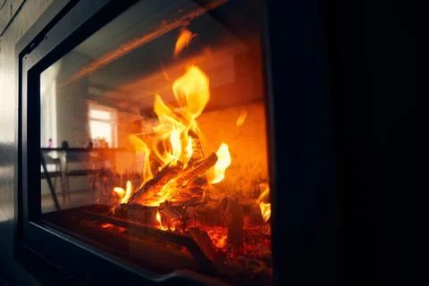 A fire burns in a fireplace, Fire to keep warm. Logs burning in a fireplace Stock Photos