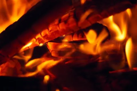 A fire burns in a fireplace, Fire to keep warm. Logs burning in a fireplace Stock Photos