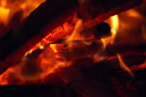 A fire burns in a fireplace, Fire to keep warm. Logs burning in Stock Photos