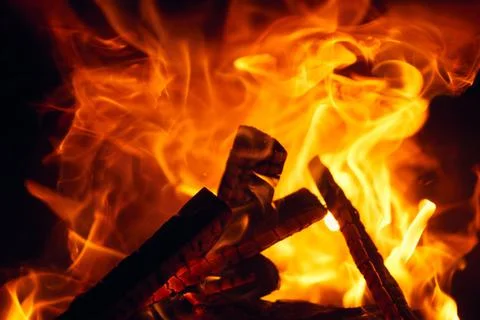 A fire burns in a fireplace, Fire to keep warm. Logs burning in Stock Photos