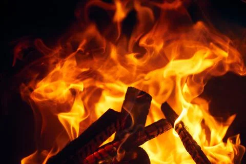 A fire burns in a fireplace, Fire to keep warm. Logs burning in Stock Photos
