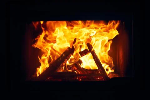 Fire burns in a fireplace, Fire to keep warm. Logs burning in Stock Photos