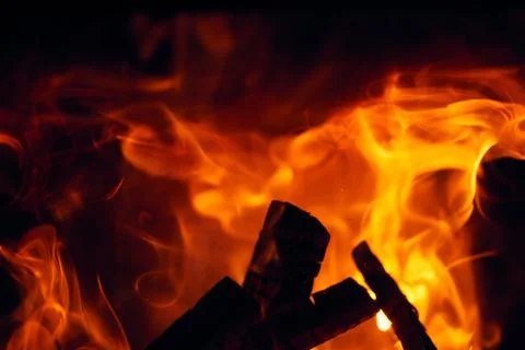 A fire burns in a fireplace, Fire to keep warm. Logs burning in a fireplace Stock Photos
