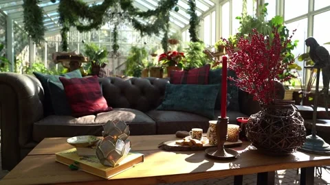 A fire burns in the fireplace, opposite a cozy sofa with pillows. Stock Footage 145085278