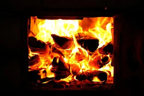 A fire burns in a fireplace Stock Photos