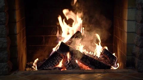 A fire burns in a fireplace, winter vacation in country house,close up. Stock Footage 257475422