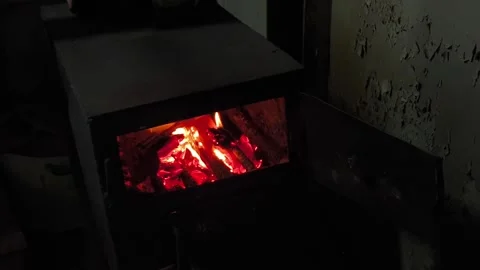 The fire burns inside the stove close-up. Fire inside the stove. Heating in the Stock Footage 322732843