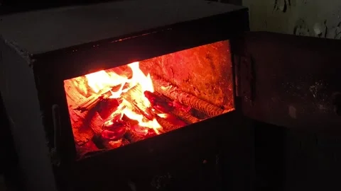 The fire burns inside the stove close-up. Fire inside the stove. Heating in the Stock Footage 322733014