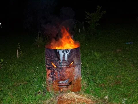 The fire burns in the night in a barrel Stock Photos