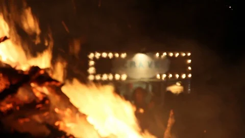 A fire burns, people chill in the back Stock Footage 122802590
