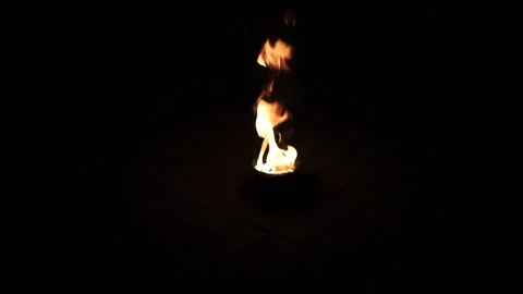 Fire burns in a plate on the ground Stockbeeldmateriaal 140358712