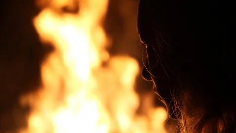 A fire burns right in front of her Stock Footage 122355522