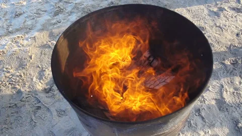 Fire burns in slow motion in an iron barrel Stock Footage 147655614