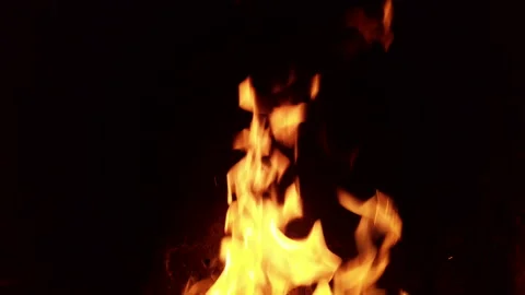 Fire burns steadily in four frames showcasing bright flames and warm glow in a Stock Footage 342369847
