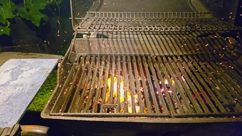 The fire burns through the grill grate. Coal for barbecue prepared by blowi.. Видео 286050532