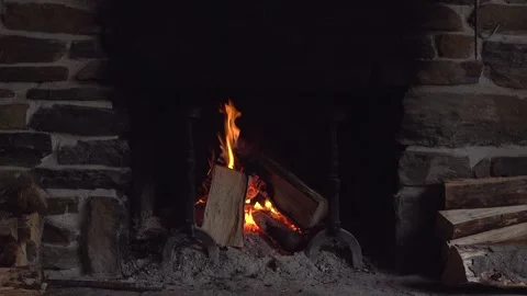 A fire burns well in a stone fireplace Stock Footage 318698443