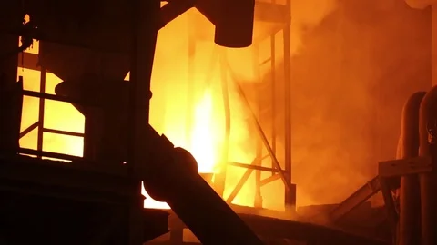Fire bursting out of the chimney of iron melting furnace, distant view Stock Footage 72754542