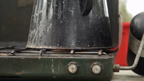 Fire of camping stove heating coffee Stock Footage 104877100