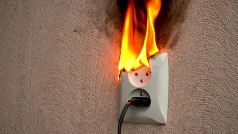 Fire caused by short circuit. The concept of a fire in the house Stock Photos