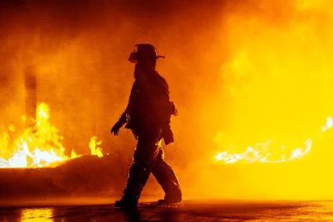 Fire chief walking in front of fire during firefighting exercise Stock Photos