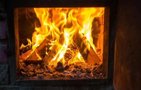 Fire in the chimney in winter time Stock Photos