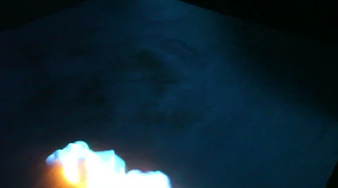 Fire up close from above on reflective surface Stock-Footage 38121786
