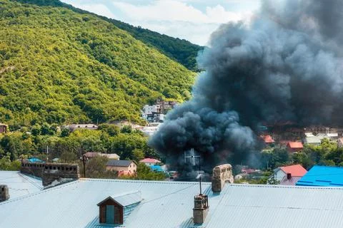 Fire. Close up of clouds of black smoke over a burning building. The concept  Stock Photos