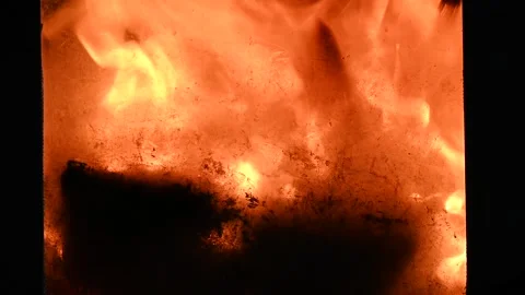 Fire in a closed fireplace as a close-up Stock Footage 233770165