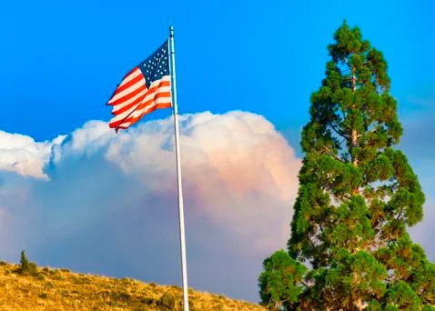 Fire Cloud Billows Behind US Flag Stock Photos