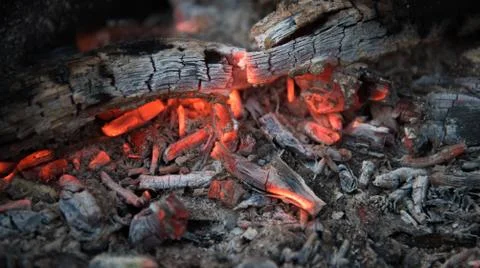 Fire with coals in the fire. Open fire, dying embers. Beautiful rich colors. Stock Photos