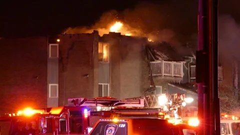 Fire coming out of top floor of apartment building with strobes Video stock 85210840