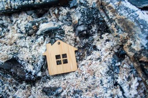 Fire concept. The house burned down. Mortgage symbol. Stock Photos
