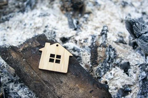 Fire concept. The house burned down. Mortgage symbol. Stock Photos