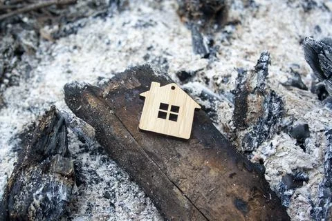 Fire concept. The house burned down. Mortgage symbol. Stock Photos